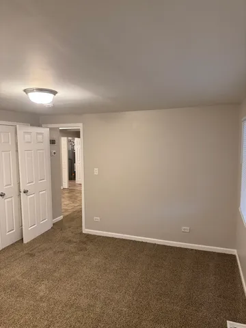 a view of an empty room and closet area
