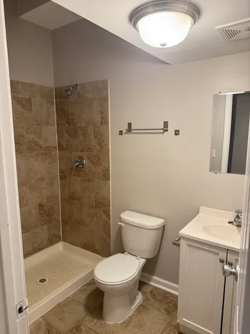 a bathroom with a shower and a toilet