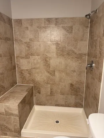 a bathroom with a sink a toilet and mirror