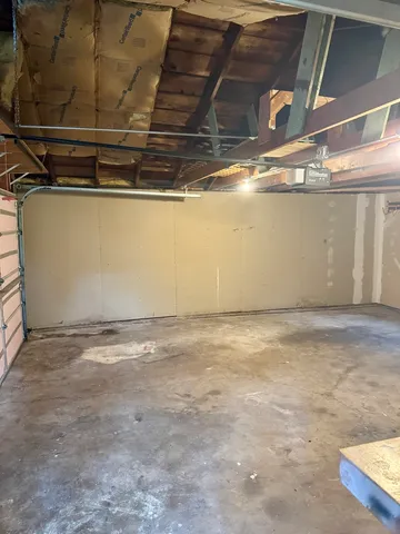 a front view of a house with a garden and trees