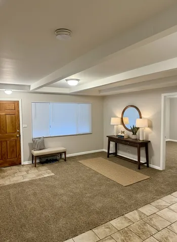 a view of a room with furniture and window