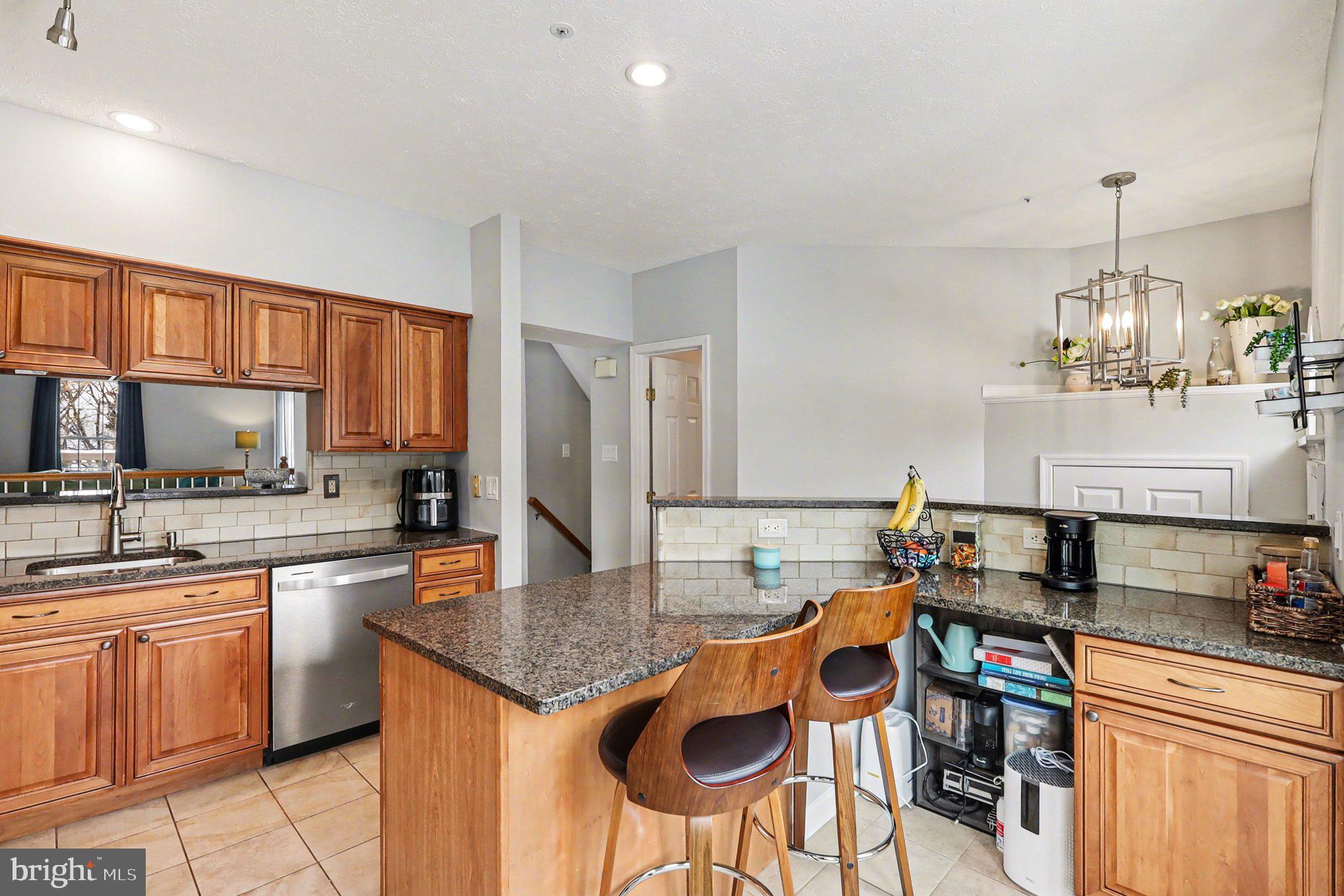 12607 Granite Ridge Drive North Potomac, MD 20878 - Photo 11 of 35 a kitchen with granite countertop a sink and cabinets
