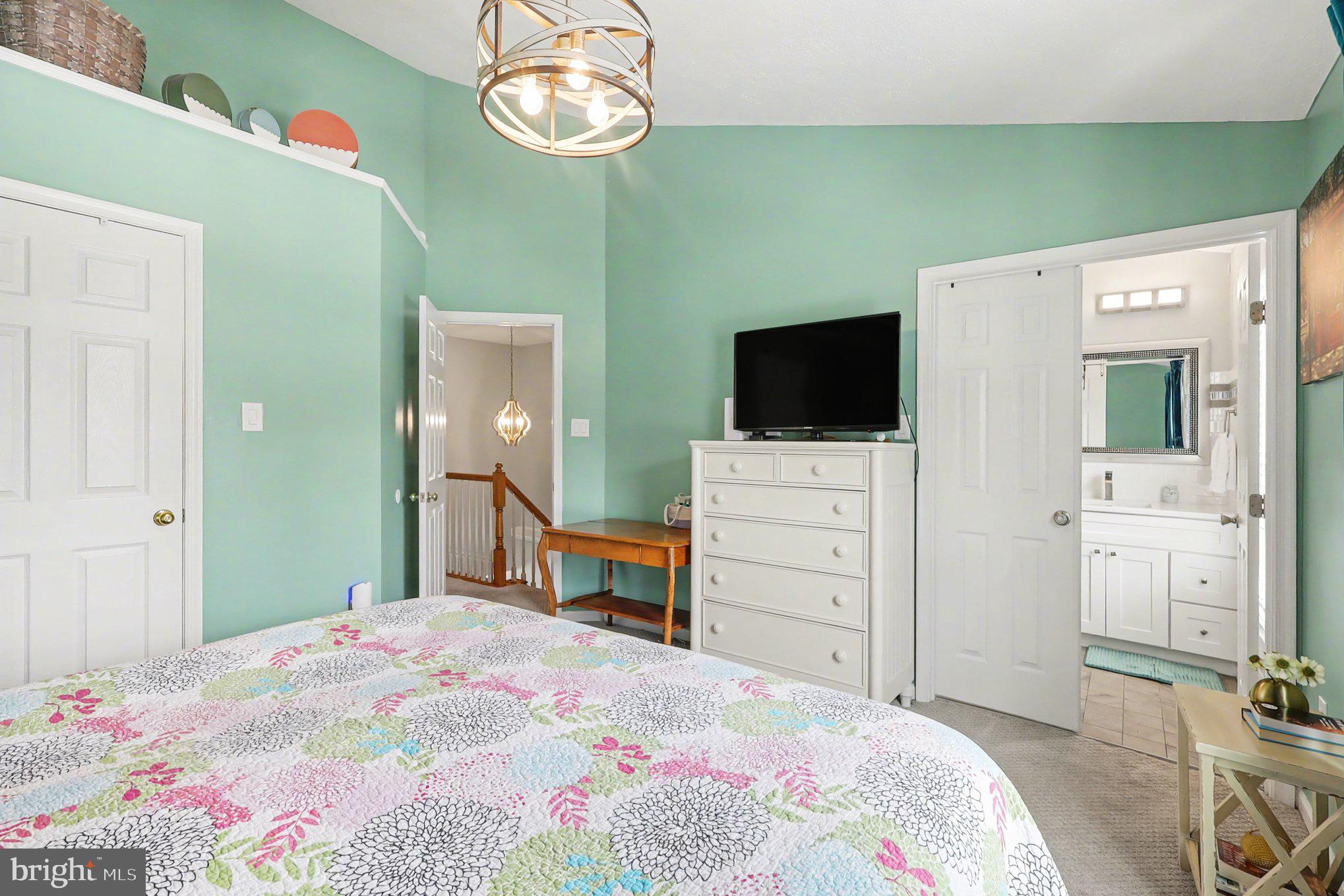 12607 Granite Ridge Drive North Potomac, MD 20878 - Photo 15 of 35 a bedroom with a bed and a flat tv screen on dresser