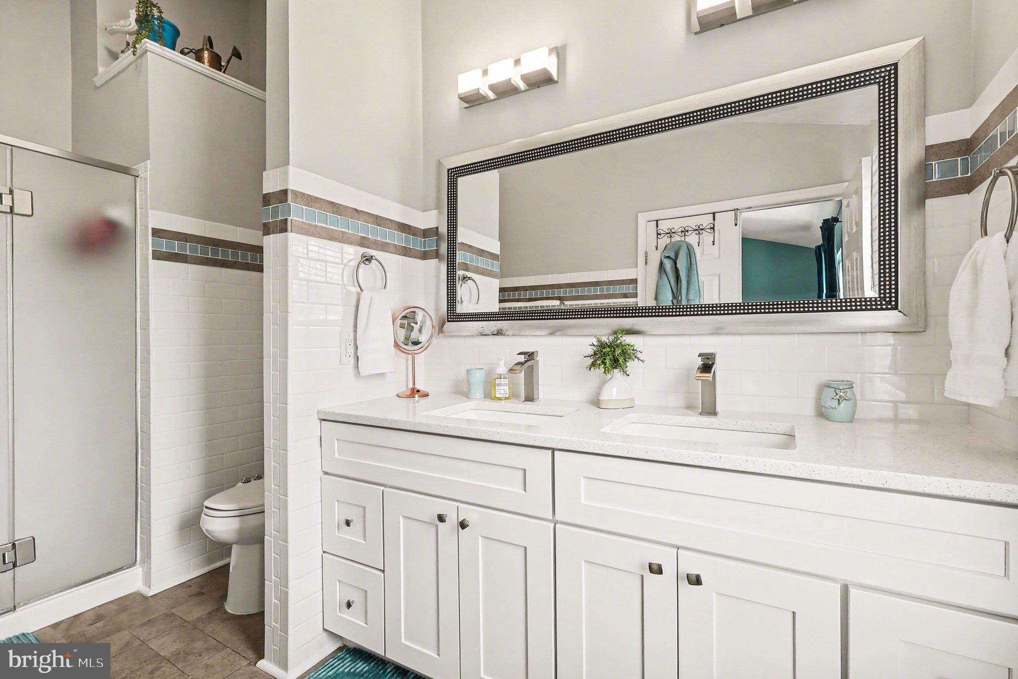 12607 Granite Ridge Drive North Potomac, MD 20878 - Photo 16 of 35 a bathroom with a granite countertop sink vanity mirror and toilet