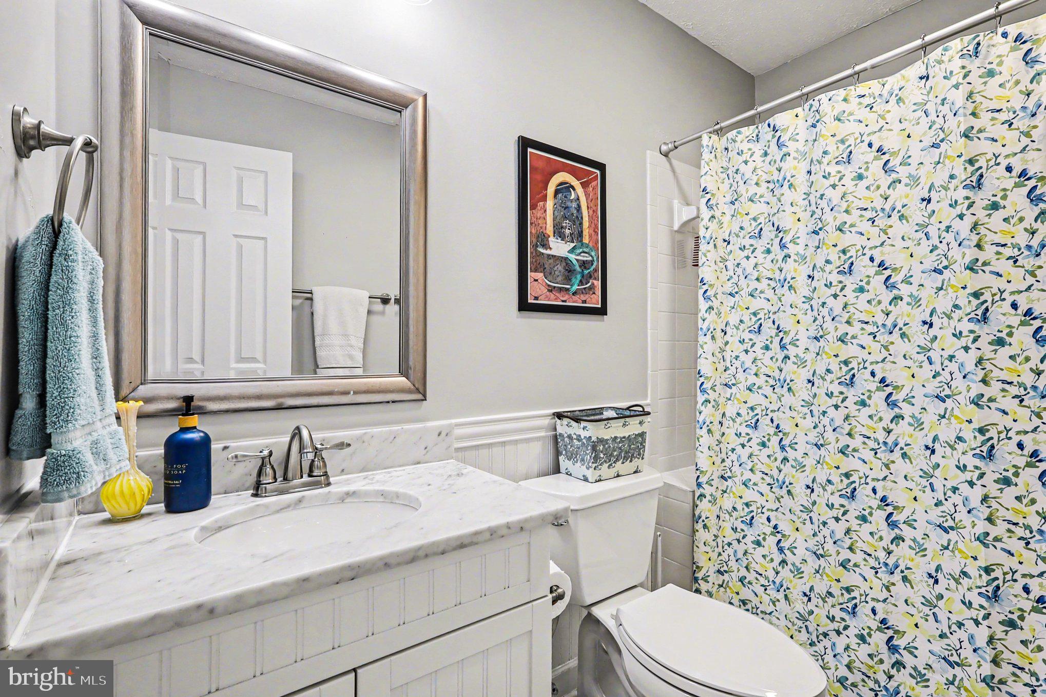 12607 Granite Ridge Drive North Potomac, MD 20878 - Photo 22 of 35 a bathroom with a granite countertop sink and a mirror