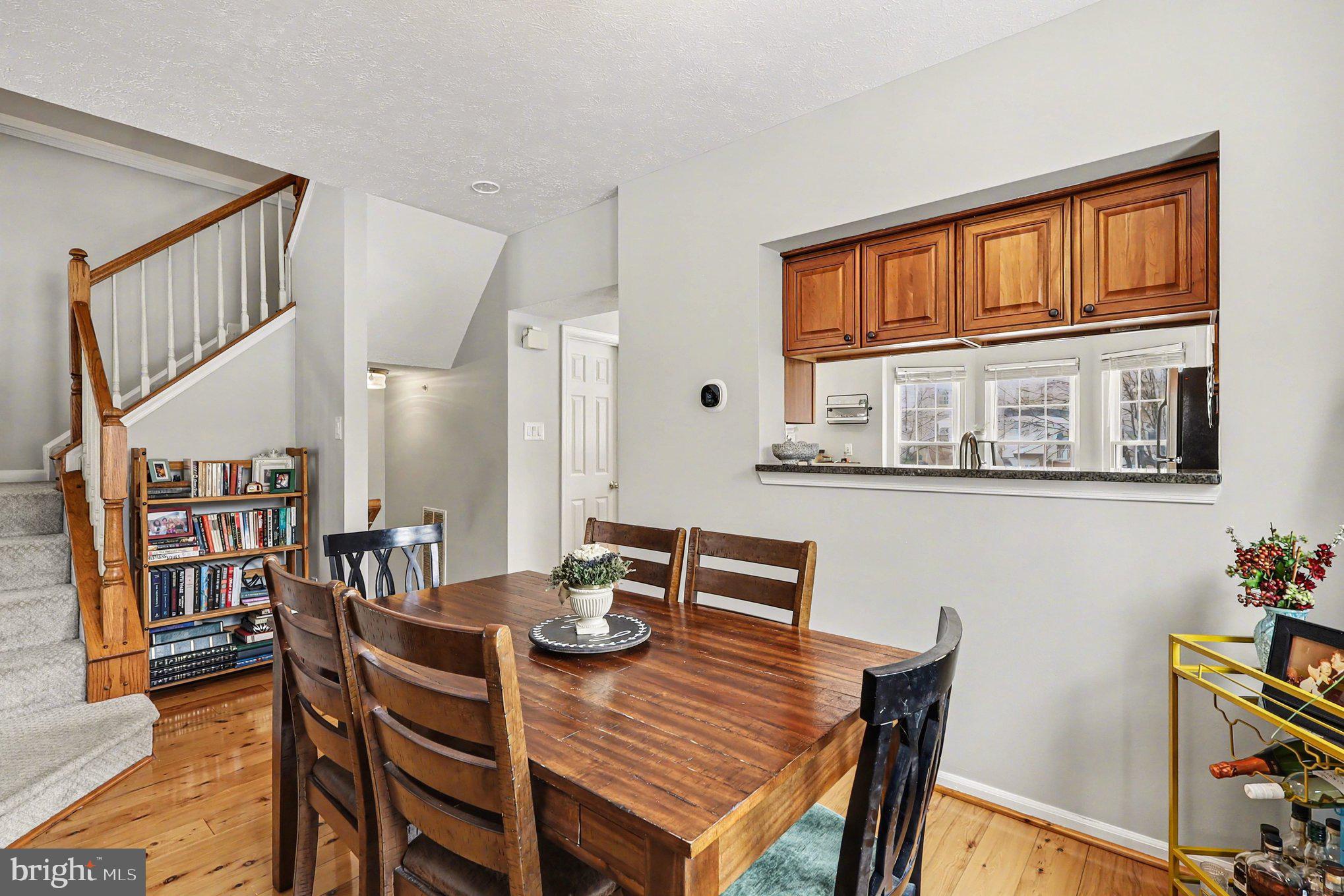 12607 Granite Ridge Drive North Potomac, MD 20878 - Photo 8 of 35 a view of a dining room with furniture and a potted plant