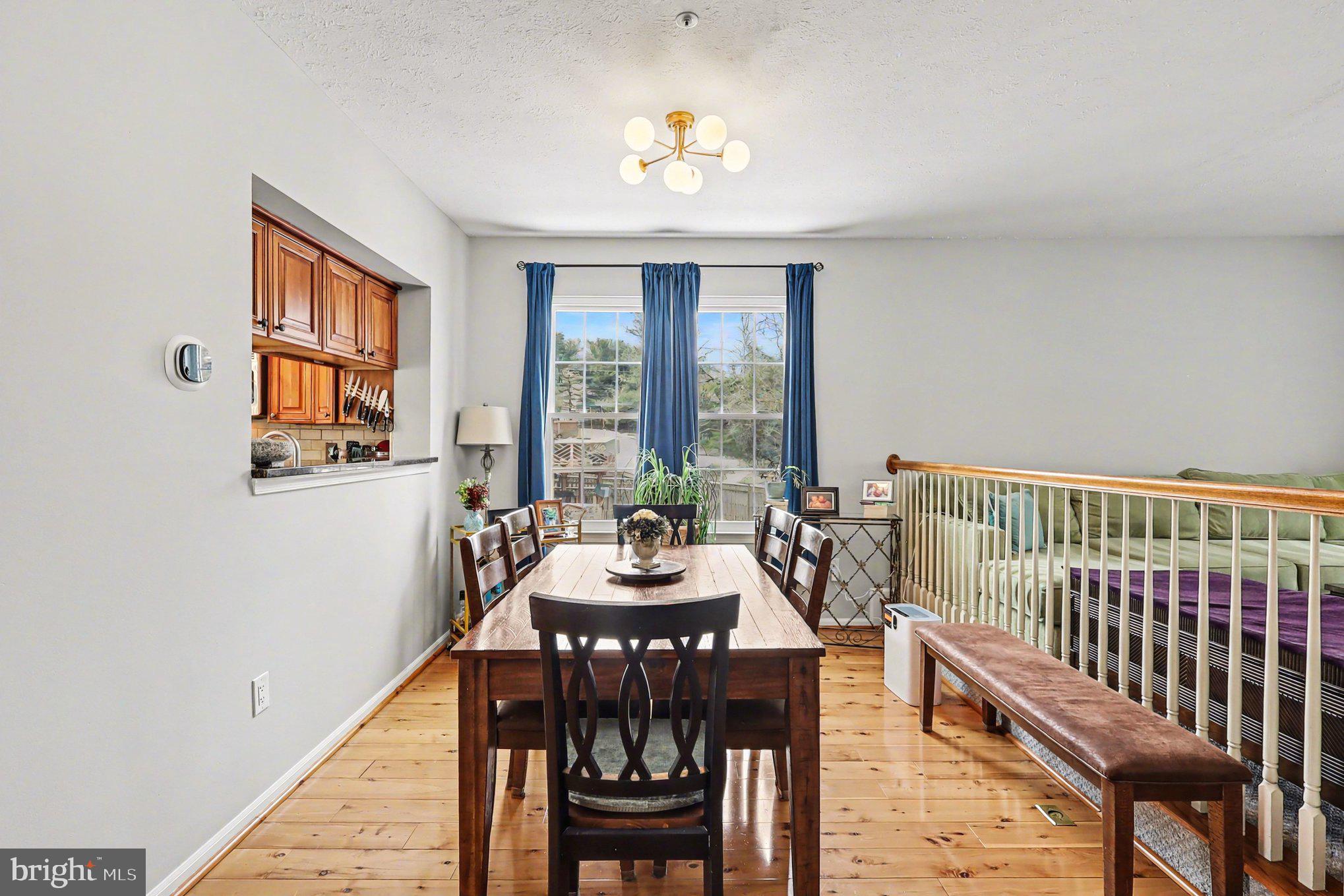 12607 Granite Ridge Drive North Potomac, MD 20878 - Photo 9 of 35 a dining room with furniture a chandelier and wooden floor