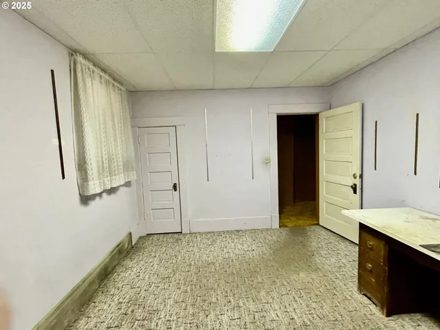 a room with a sink a refrigerator and window