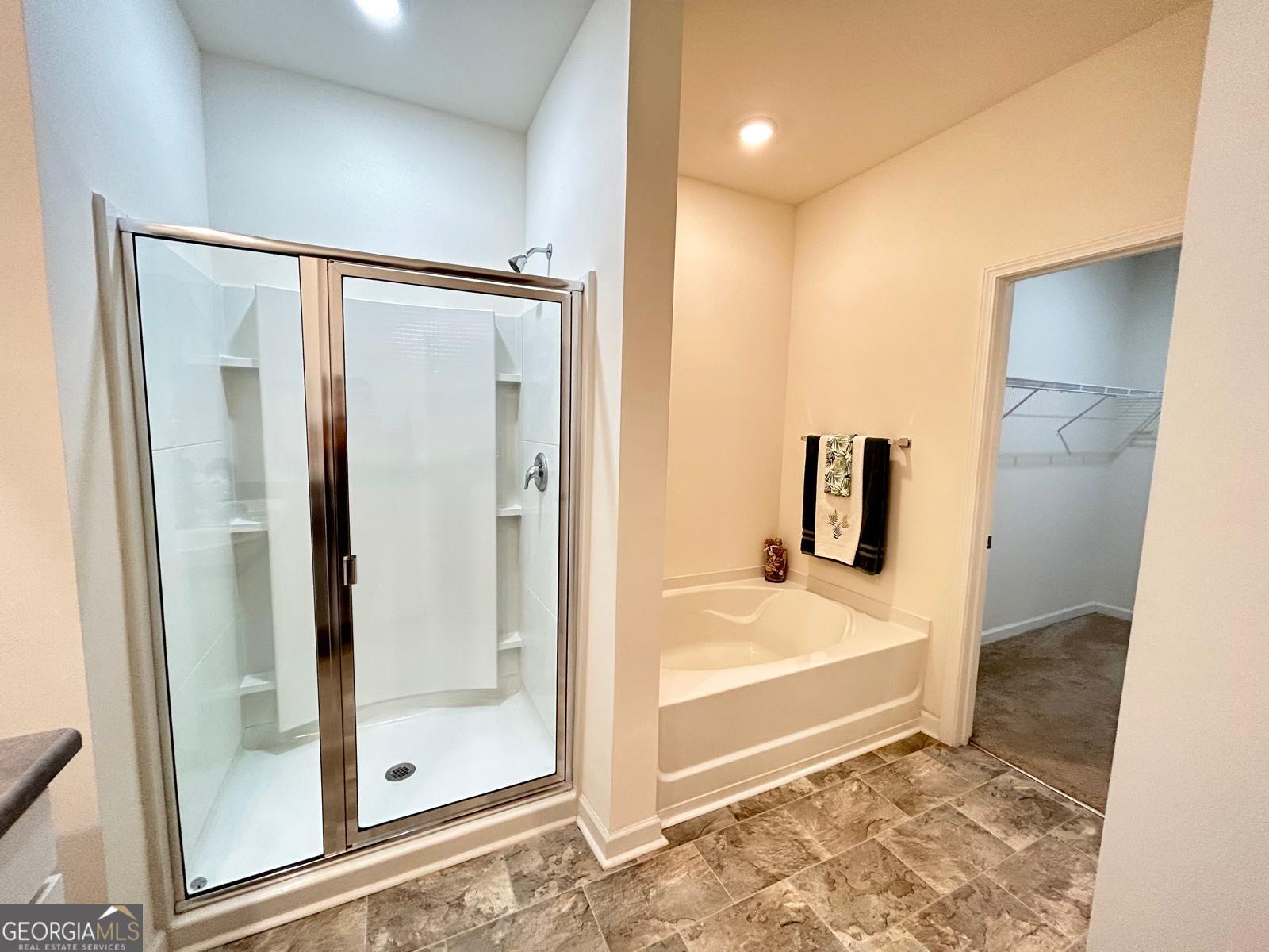 215 Barnyard Way Perry, GA 31069 - Photo 20 of 29 a bathroom with a tub and a shower