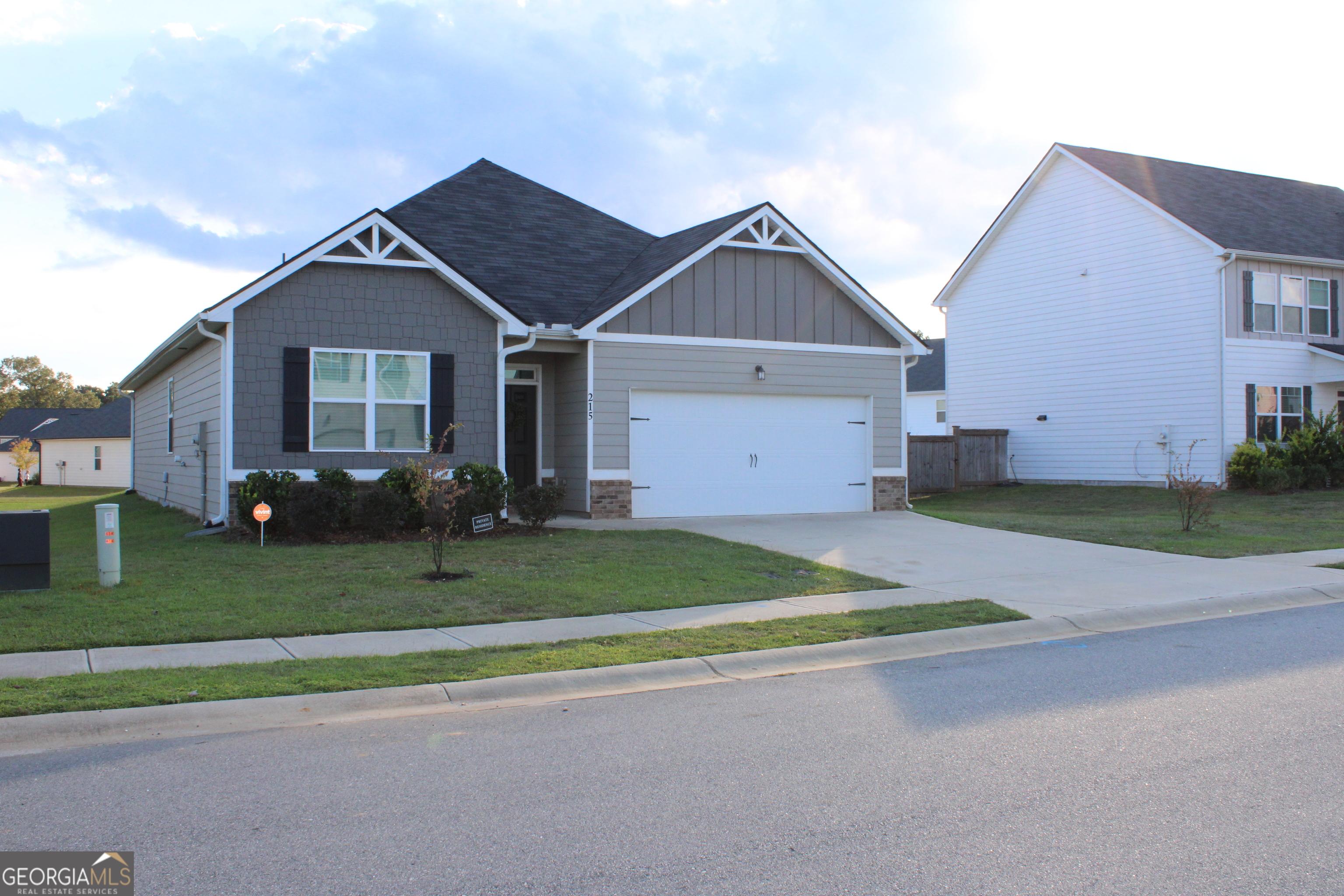215 Barnyard Way Perry, GA 31069 - Photo 2 of 29 a front view of a house with a yard and garage