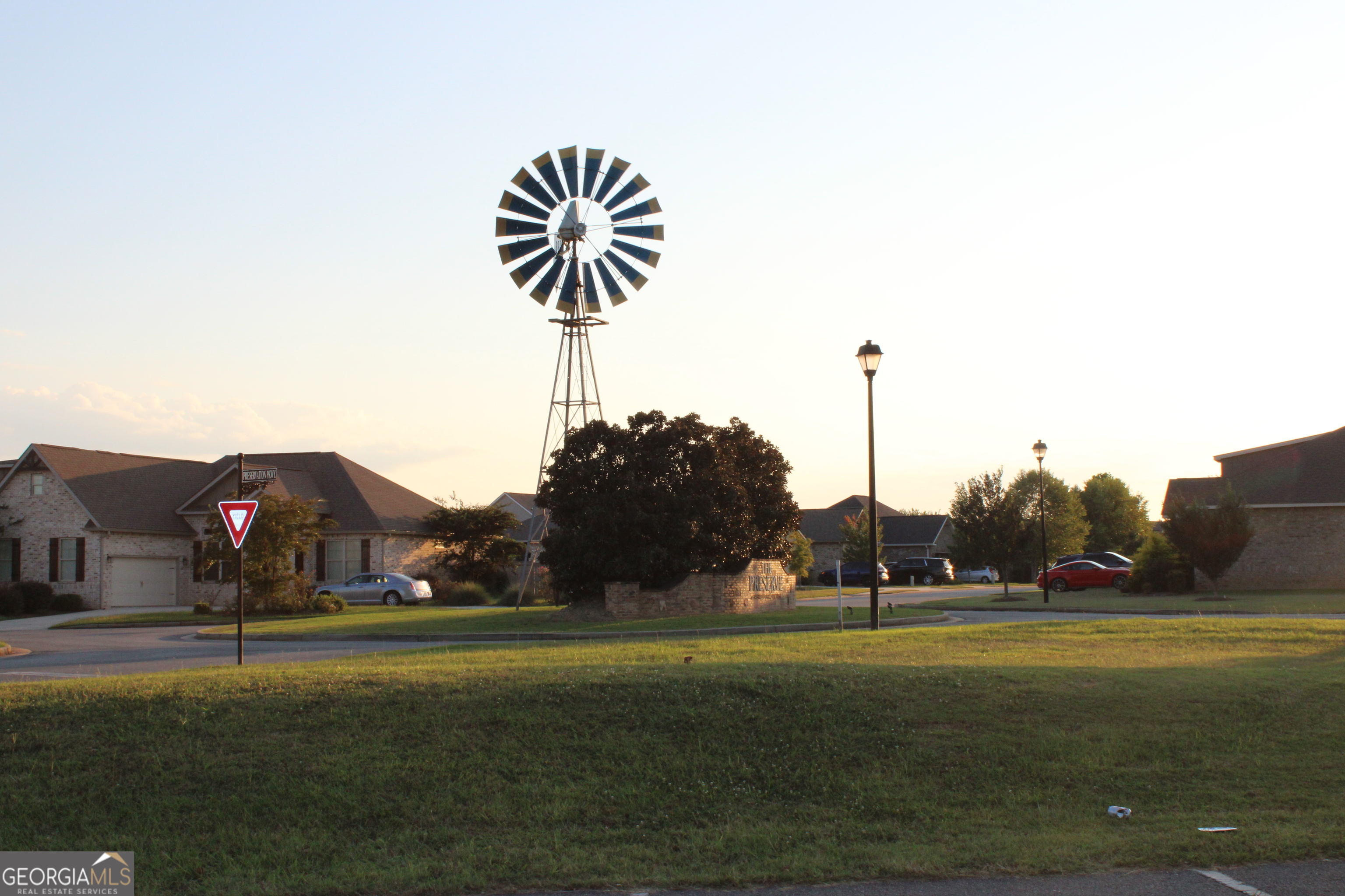 215 Barnyard Way Perry, GA 31069 - Photo 24 of 29 a front view of a house with garden and trees