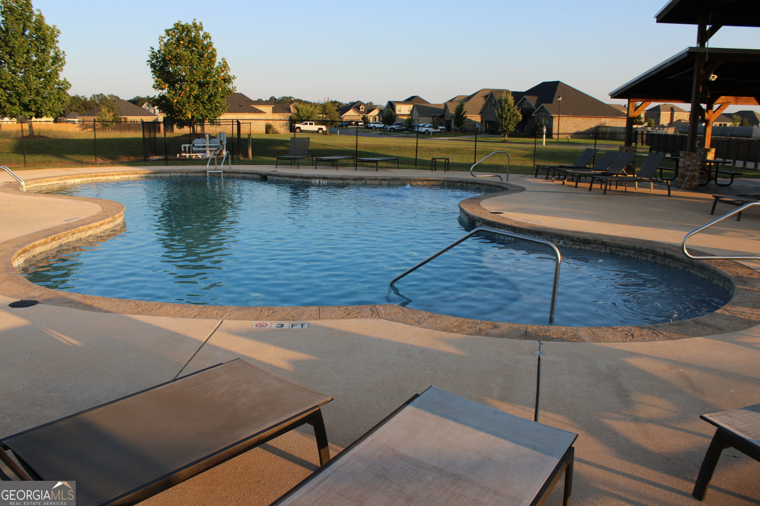 215 Barnyard Way Perry, GA 31069 - Photo 25 of 29 a view of a lake with couches chairs