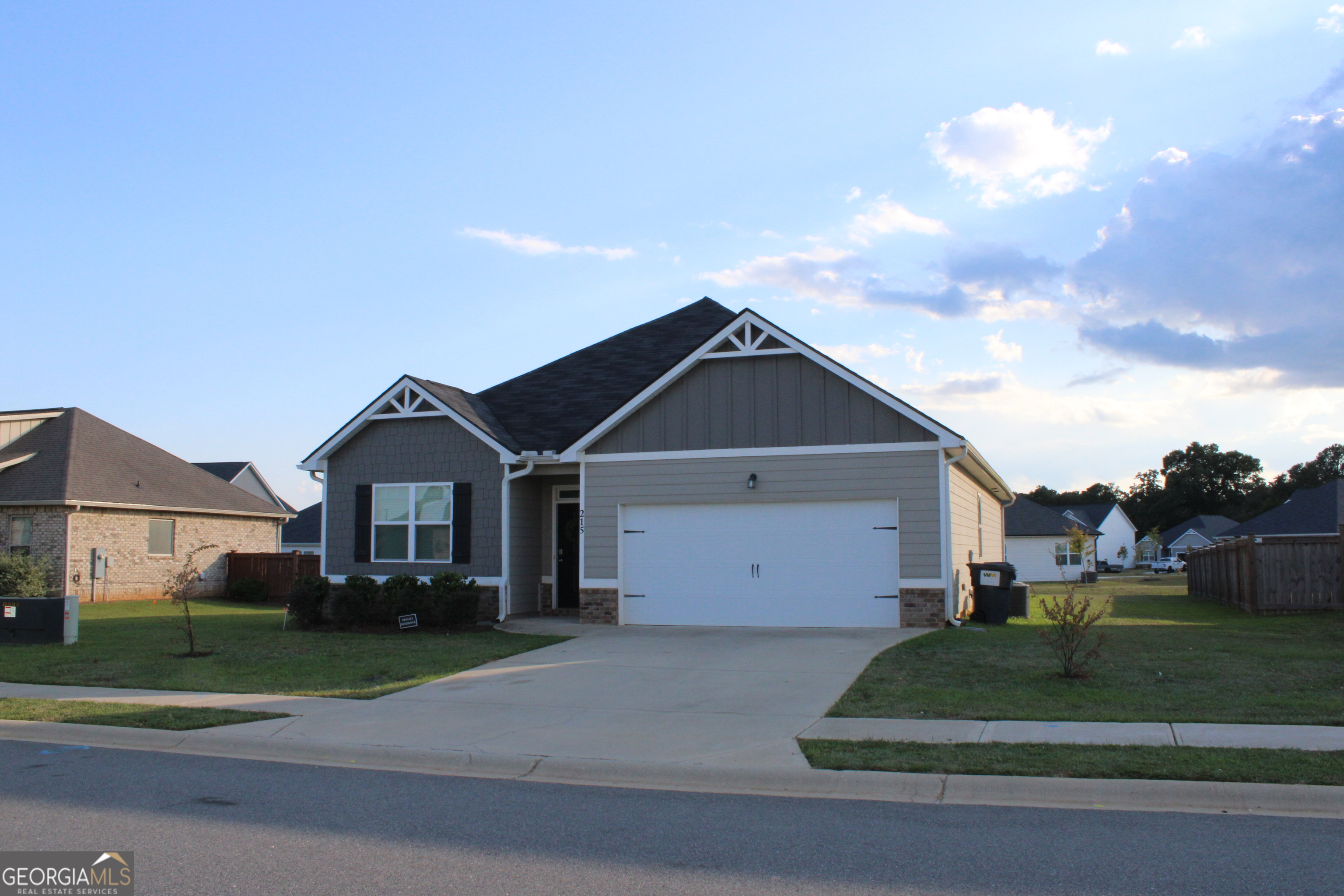 215 Barnyard Way Perry, GA 31069 - Photo 3 of 29 a front view of a house with a yard