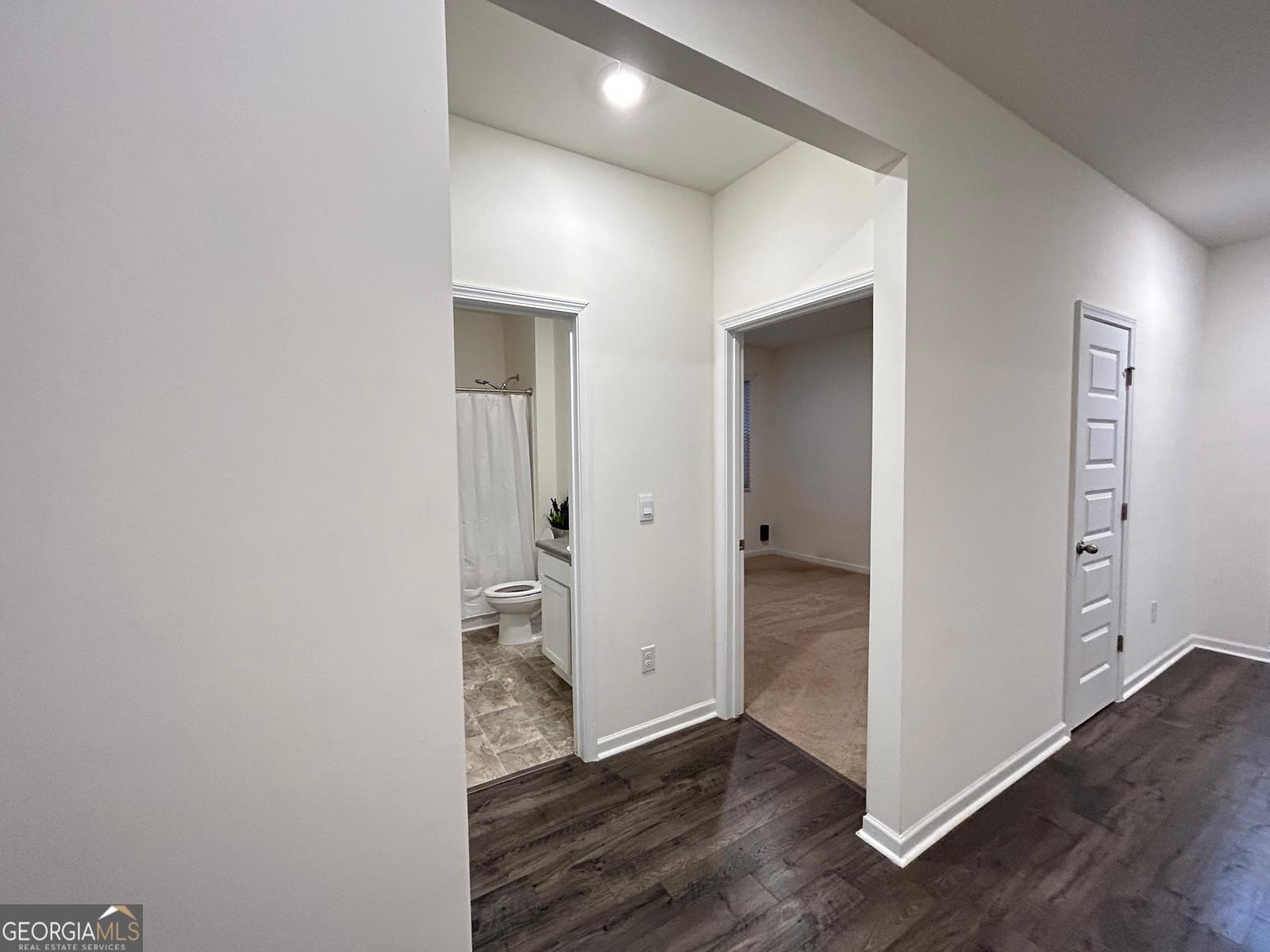 215 Barnyard Way Perry, GA 31069 - Photo 5 of 29 an empty room with wooden floor & windows