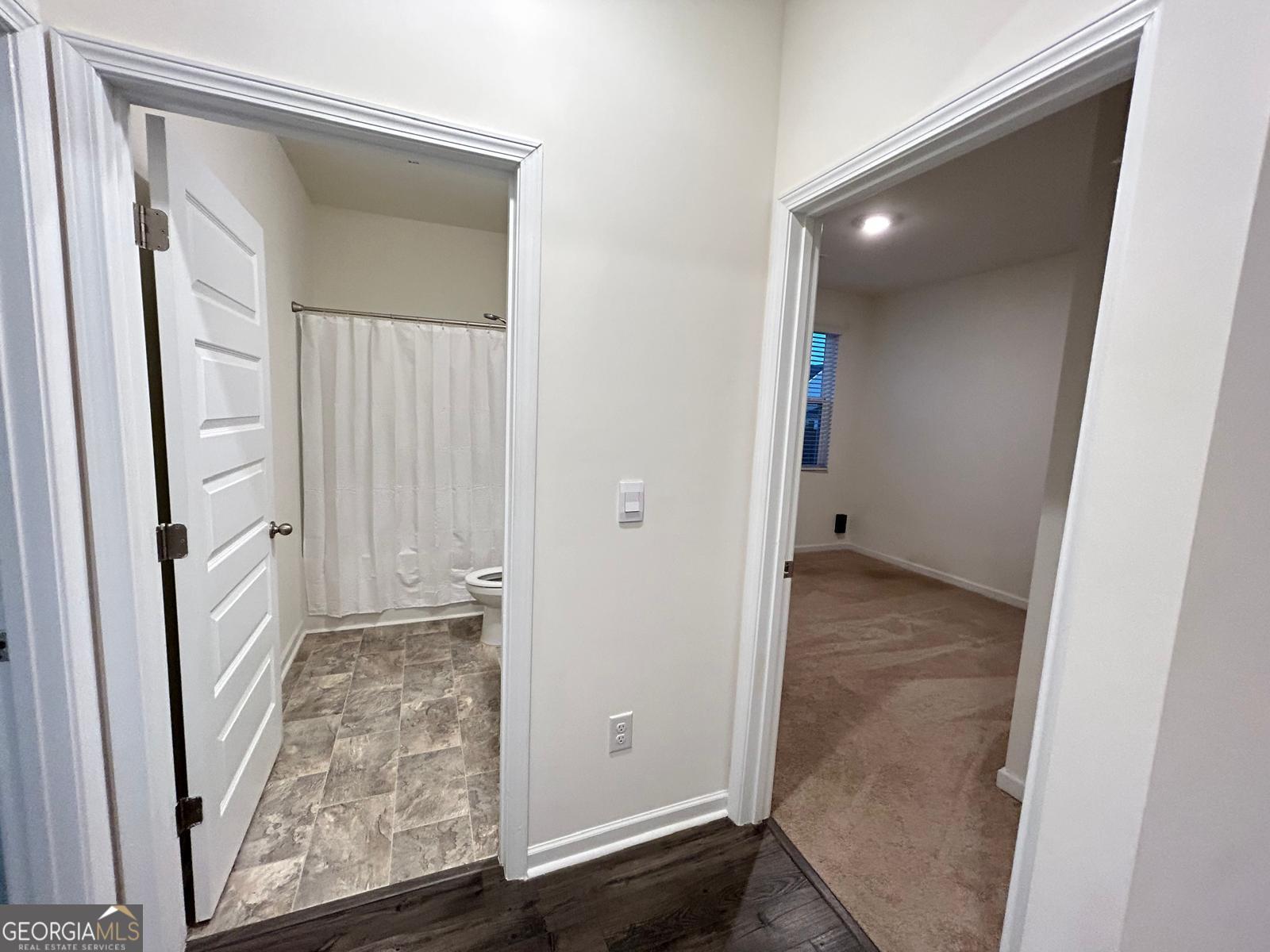 215 Barnyard Way Perry, GA 31069 - Photo 6 of 29 an empty room with wooden floor and windows