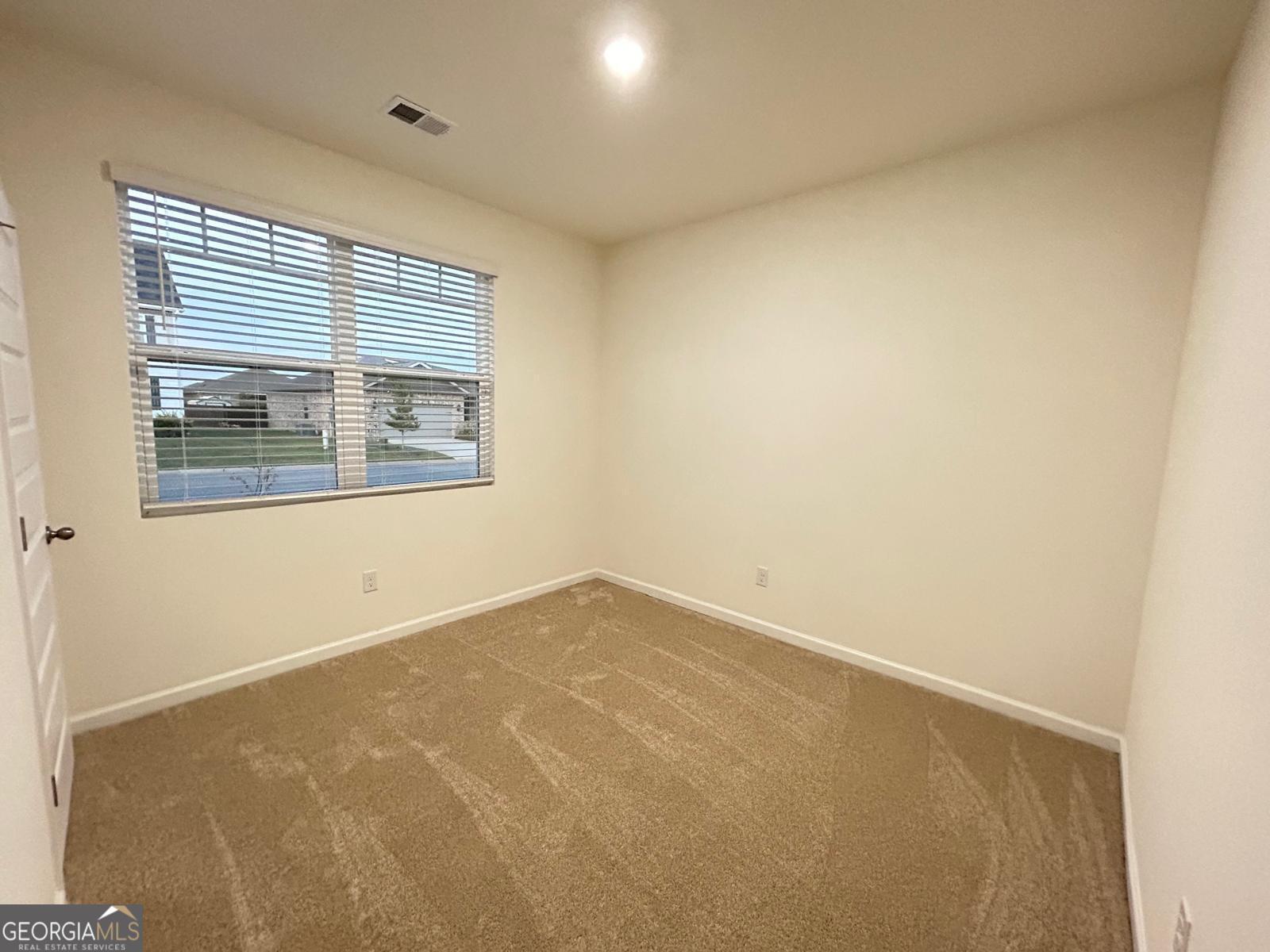 215 Barnyard Way Perry, GA 31069 - Photo 7 of 29 an empty room with a window