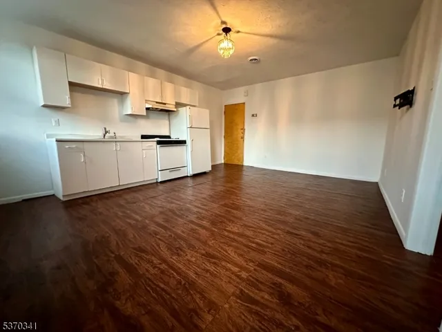 a view of kitchen with wooden floor electronic appliances and window