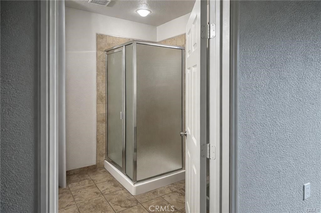 494 Alta Mesa Drive Riverside, CA 92507 - Photo 4 of 9 a bathroom with a glass shower door