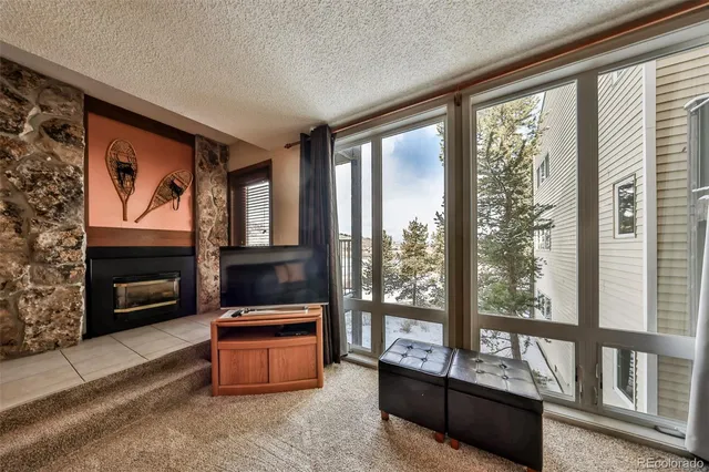 a living room with furniture and a floor to ceiling window