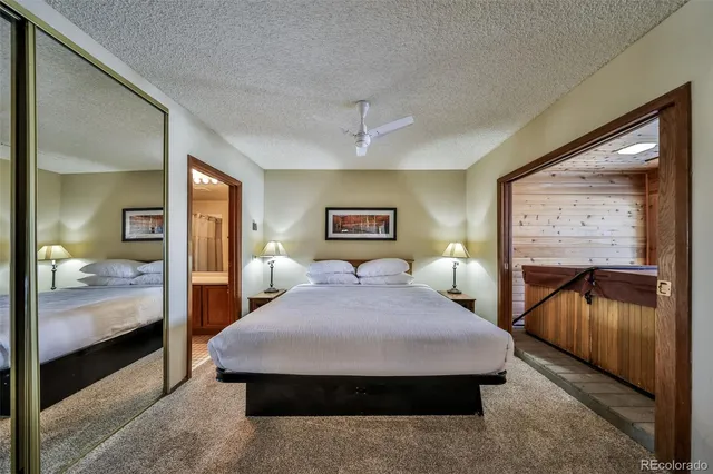 a bedroom with a large bed and a chandelier