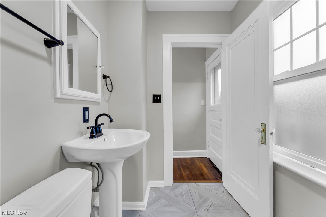 3445 Menlo Road Cleveland, OH 44120 - Photo 24 of 35 Bathroom featuring toilet, sink, and hardwood floors