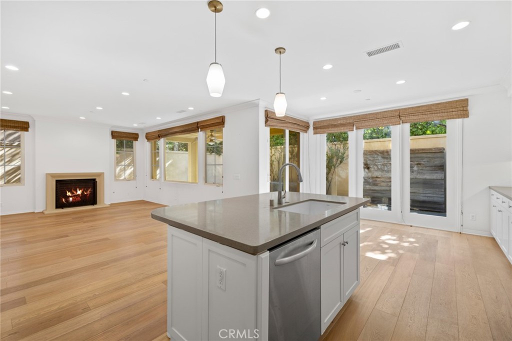 a kitchen with stainless steel appliances granite countertop a kitchen island a stove and a wooden floors