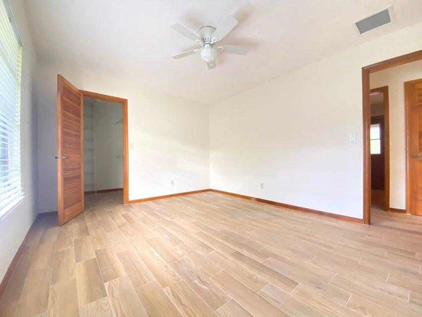5585 Pennock Point Road Jupiter, FL 33458 - Photo 13 of 19 wooden floor in an empty room with a window