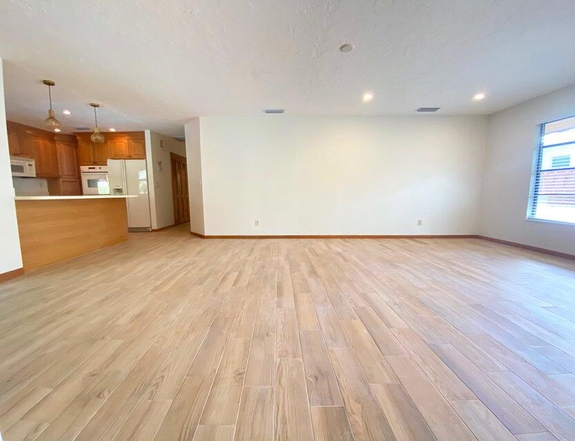 5585 Pennock Point Road Jupiter, FL 33458 - Photo 2 of 19 a view of an empty room with wooden floor and a window