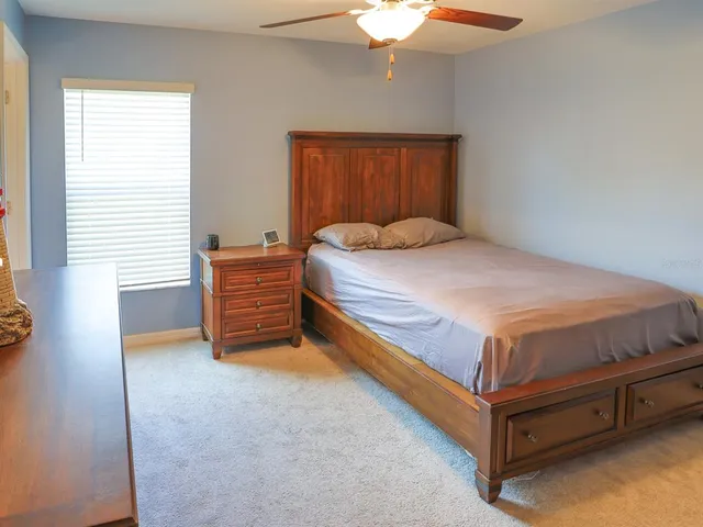 a bed sitting in a bedroom next to a window