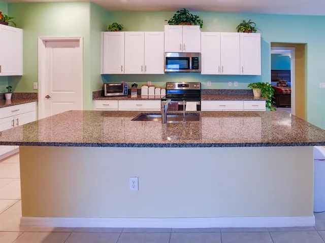 a kitchen with stainless steel appliances granite countertop a sink and cabinets