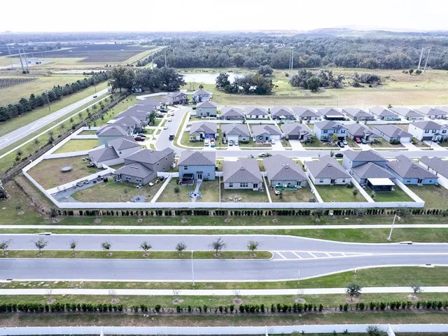an aerial view of a house with a swimming pool