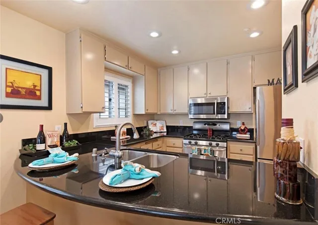 a kitchen with a appliances and cabinets