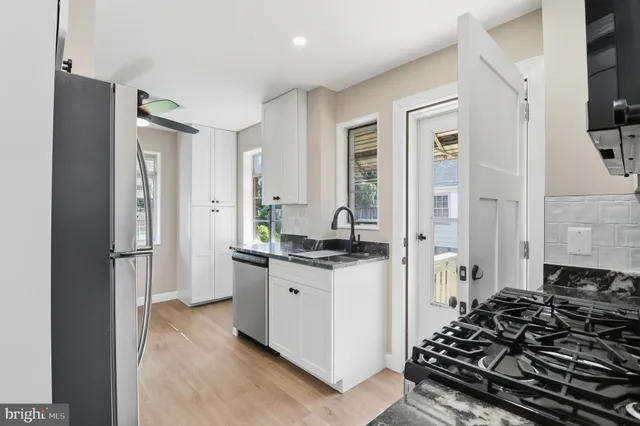 a kitchen with a refrigerator and a stove