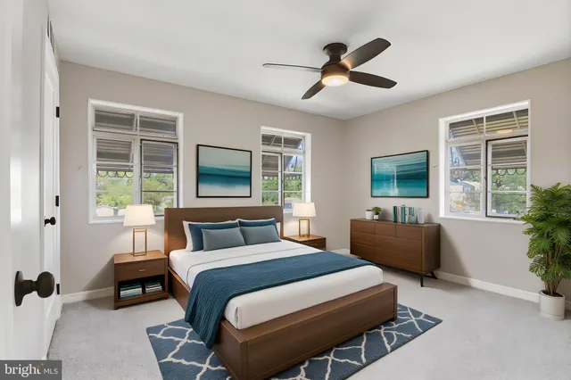 a bedroom with bed and a potted plant