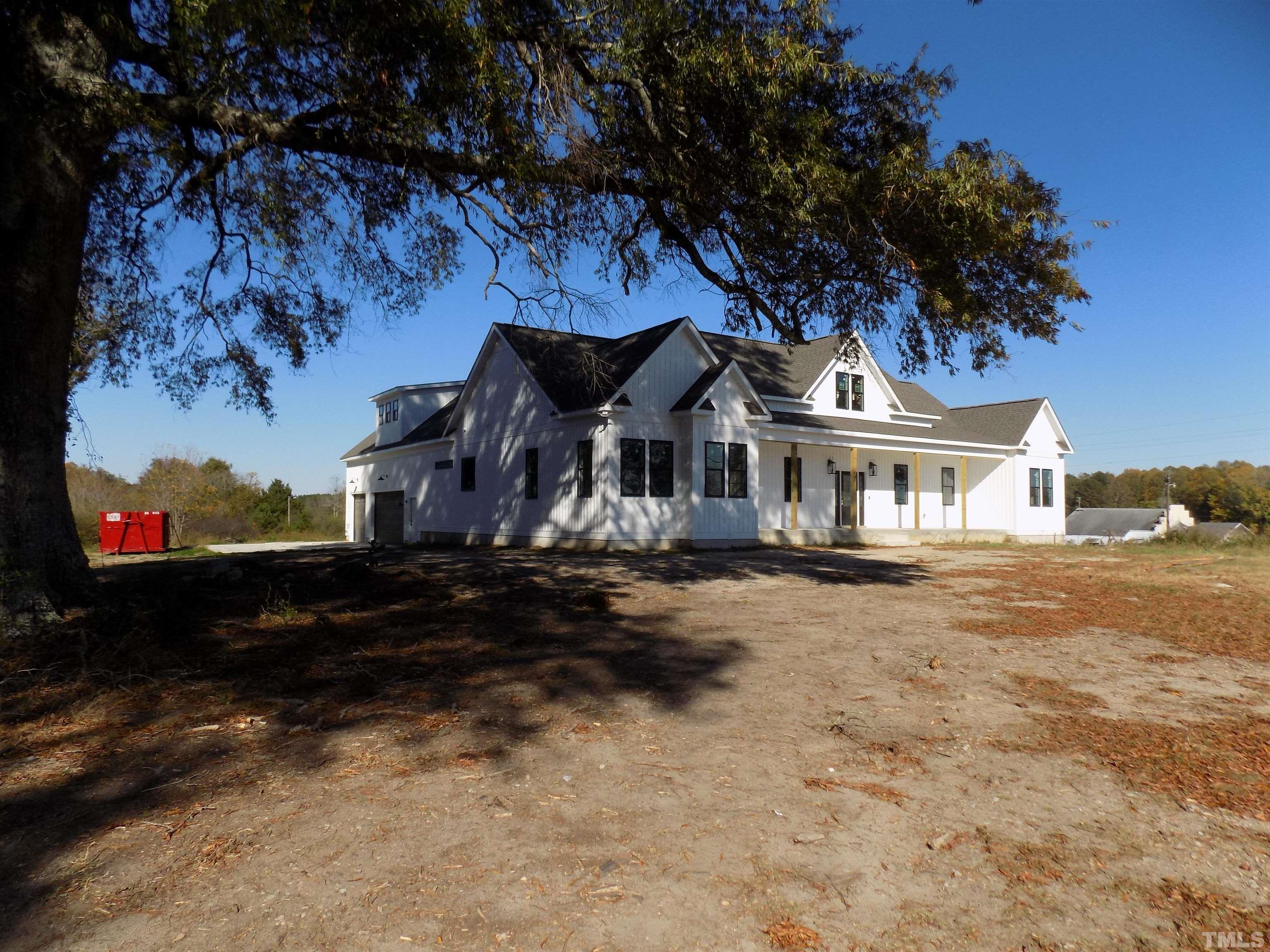 4561 Highway 56 Louisburg, NC 27549 - Photo 2 of 13 a front view of a house with a yard