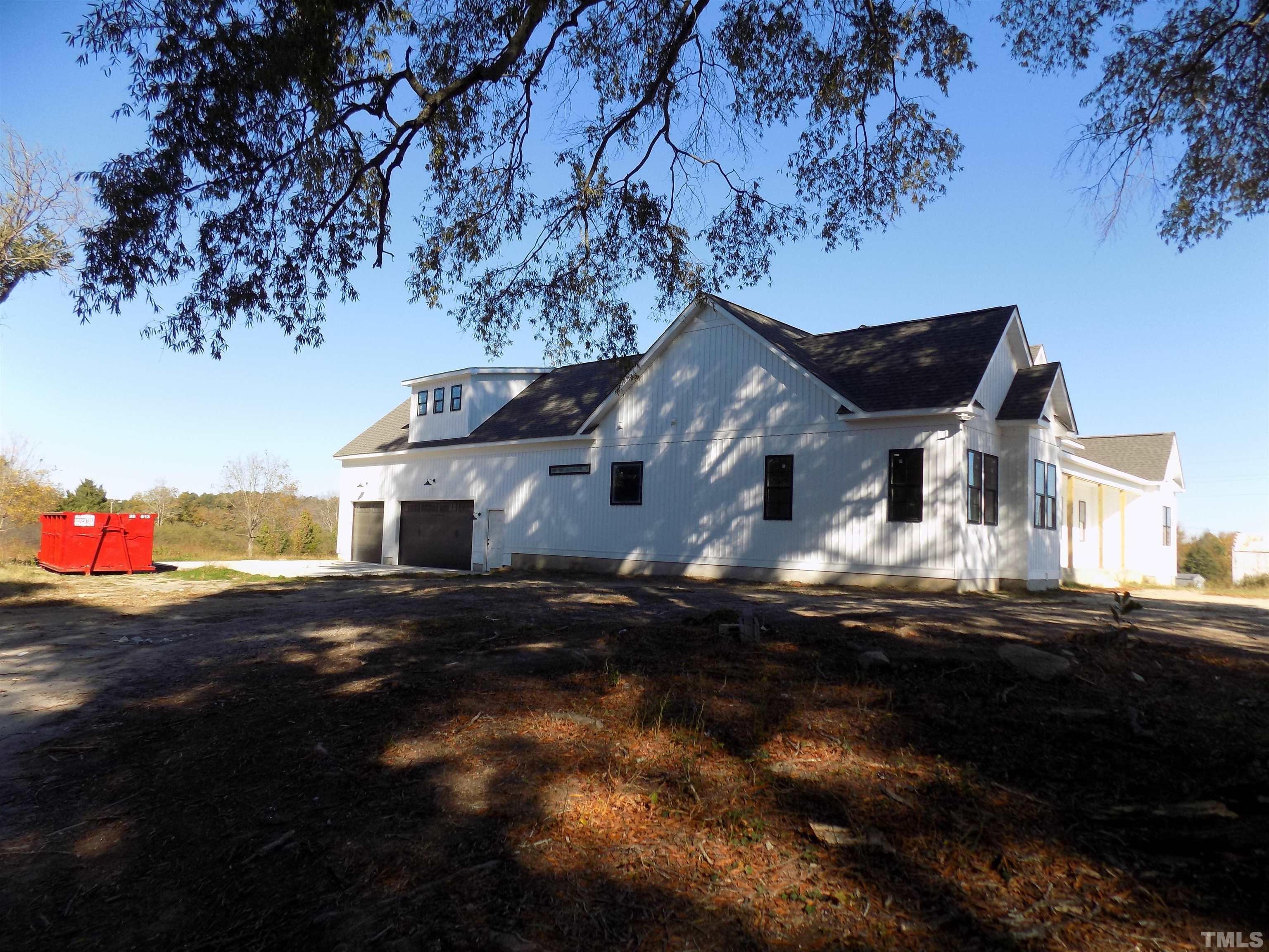 4561 Highway 56 Louisburg, NC 27549 - Photo 3 of 13 a front view of a house with a yard