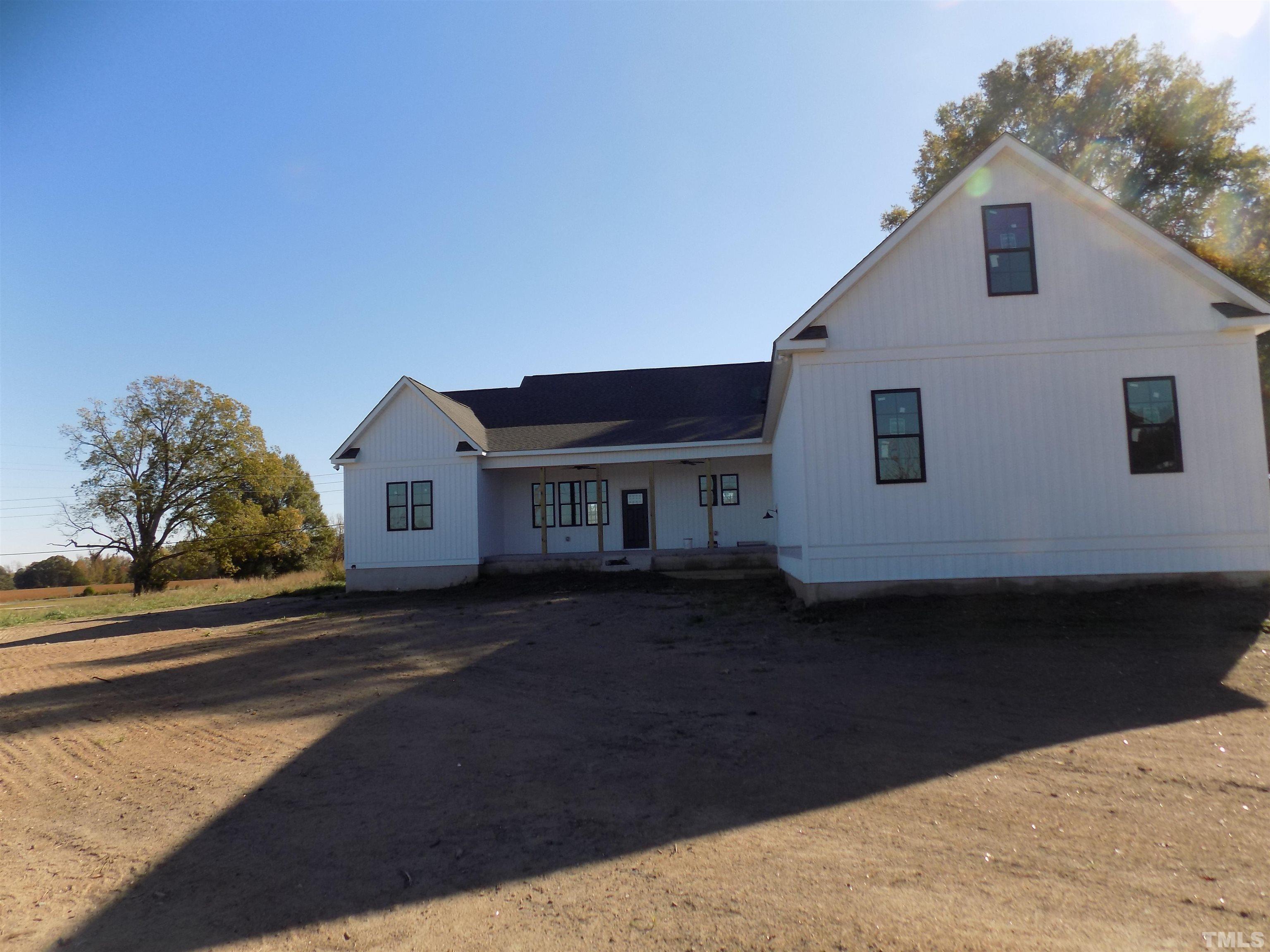 4561 Highway 56 Louisburg, NC 27549 - Photo 5 of 13 a front view of a house with a yard