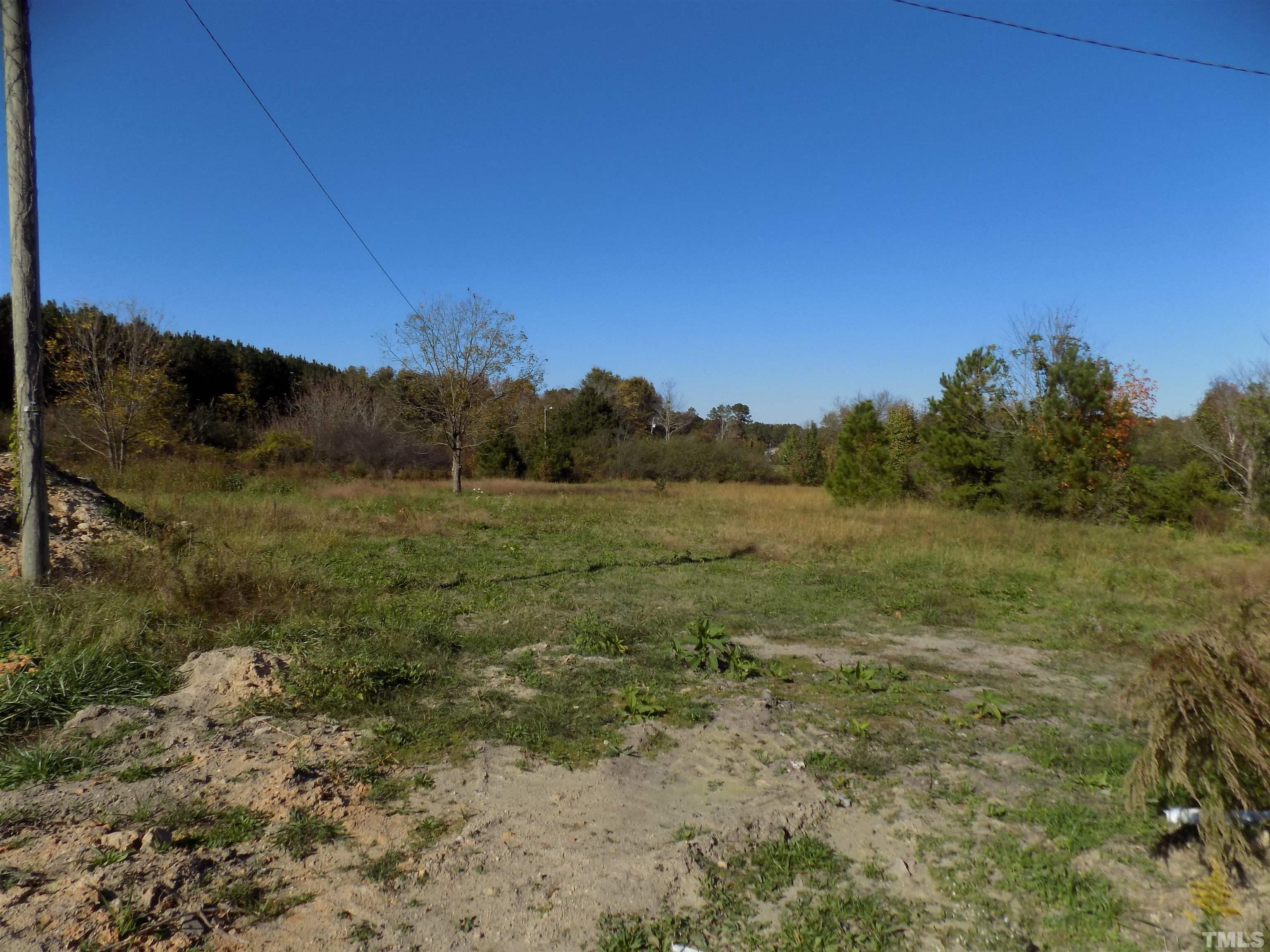 4561 Highway 56 Louisburg, NC 27549 - Photo 7 of 13 a view of a field with an trees