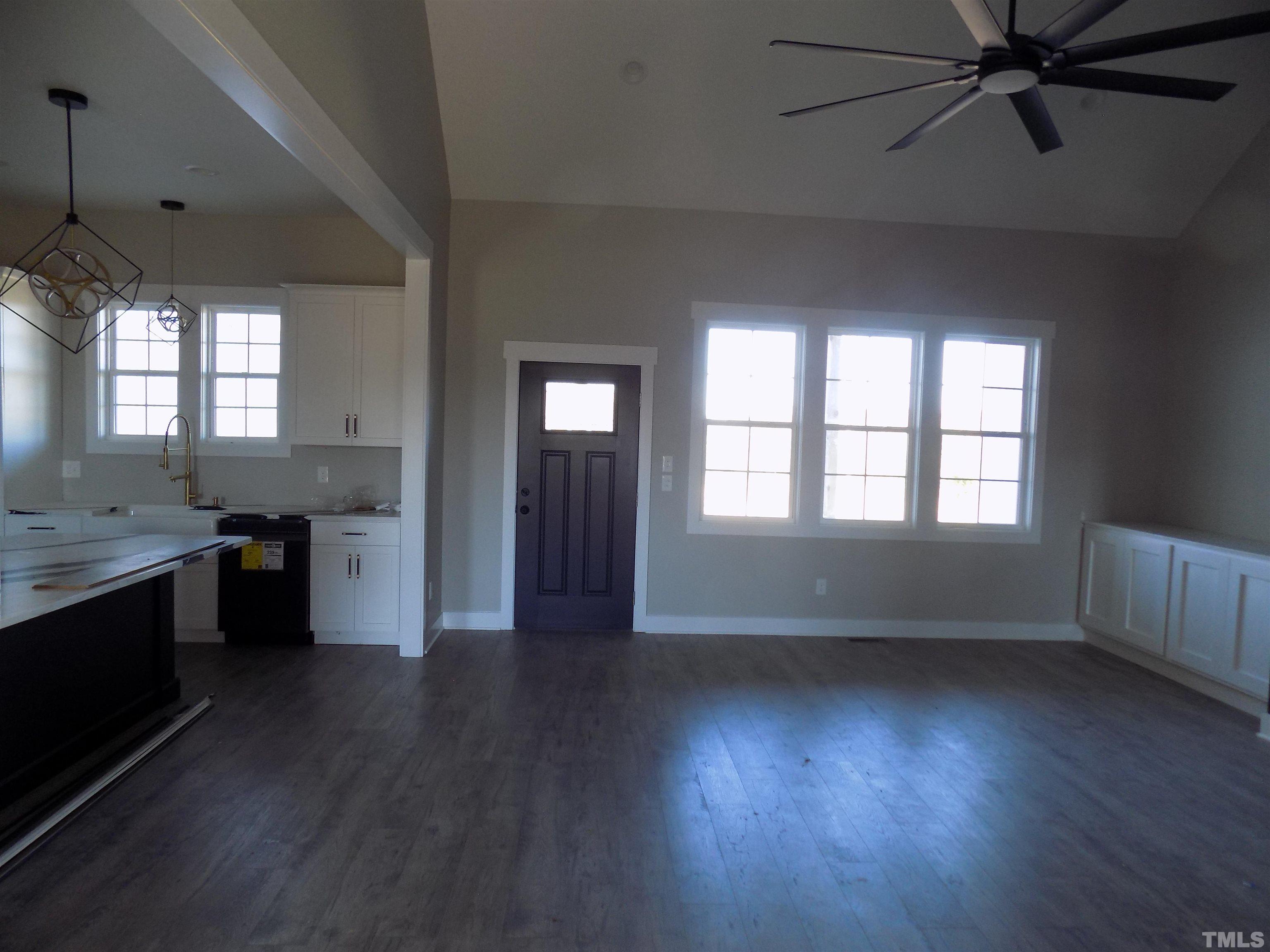 4561 Highway 56 Louisburg, NC 27549 - Photo 9 of 13 an empty room with wooden floor and windows