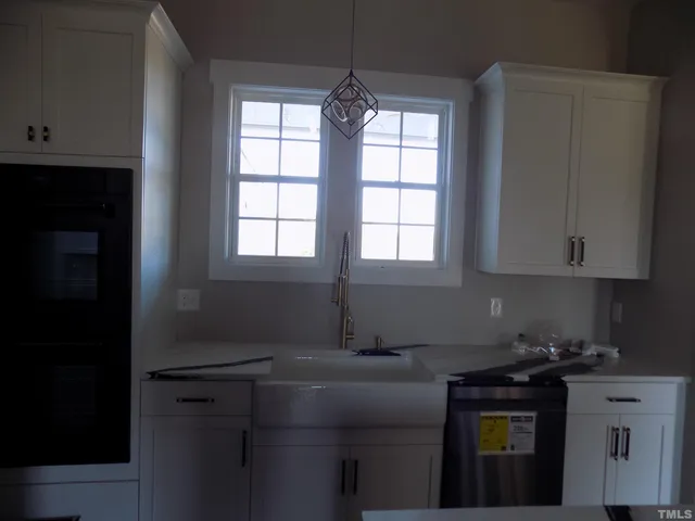 a kitchen with a stove and a window