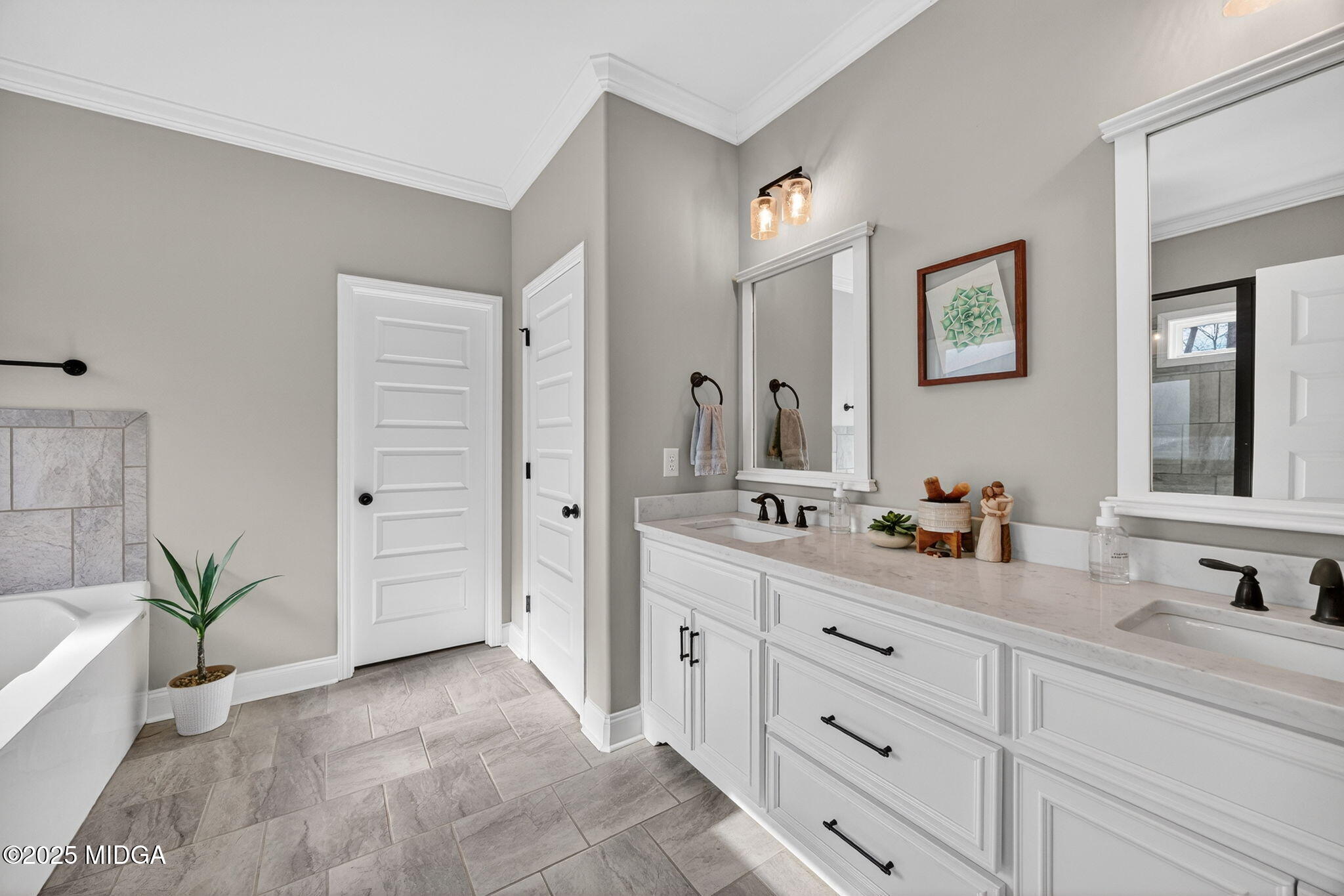 153 Jackson Drive Forsyth, GA 31029 - Photo 15 of 26 a spacious bathroom with double sink a large mirror a bathtub and