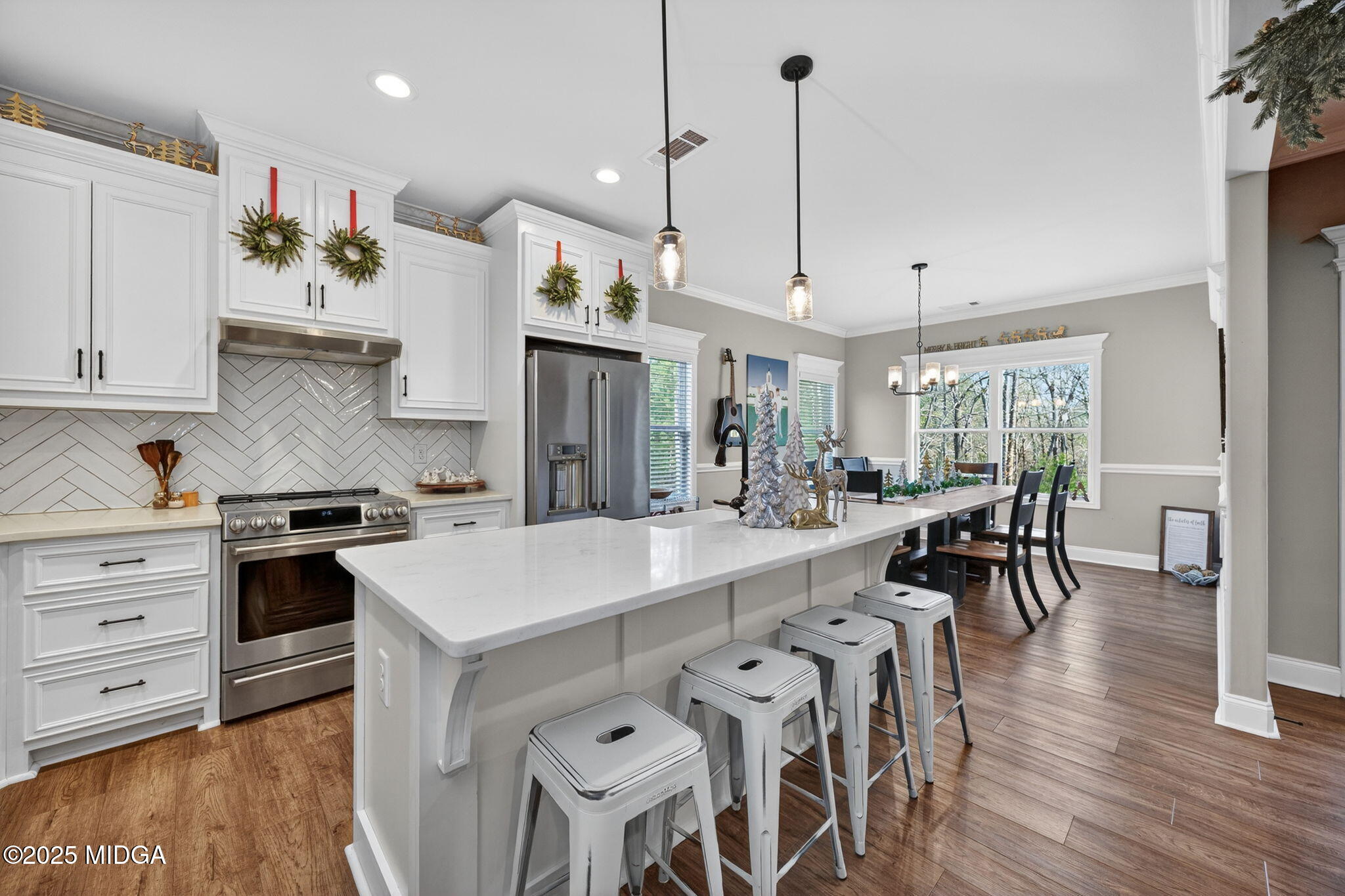 153 Jackson Drive Forsyth, GA 31029 - Photo 2 of 26 a large kitchen with kitchen island a table and chairs