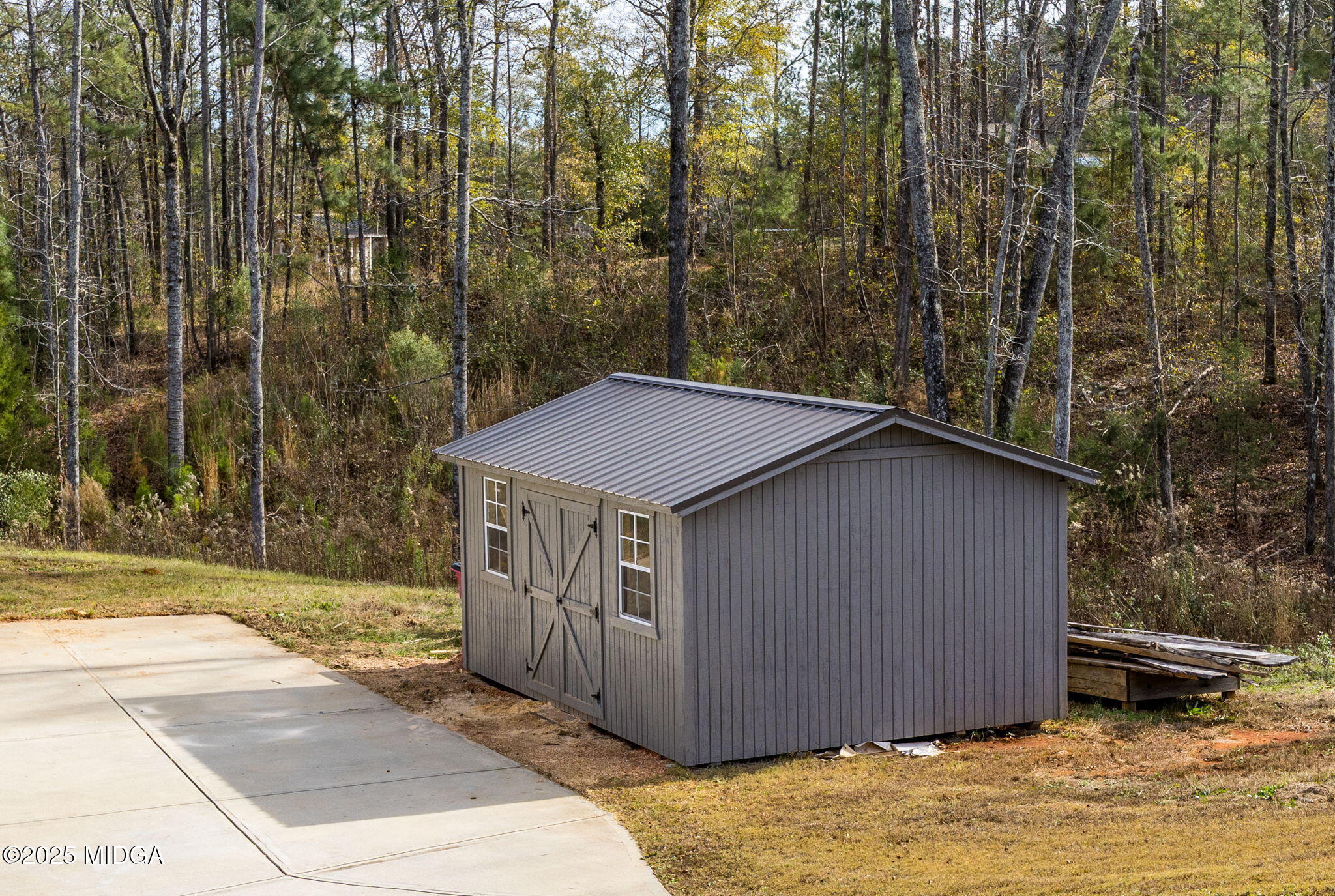 153 Jackson Drive Forsyth, GA 31029 - Photo 26 of 26 a yellow house sitting in middle of forest