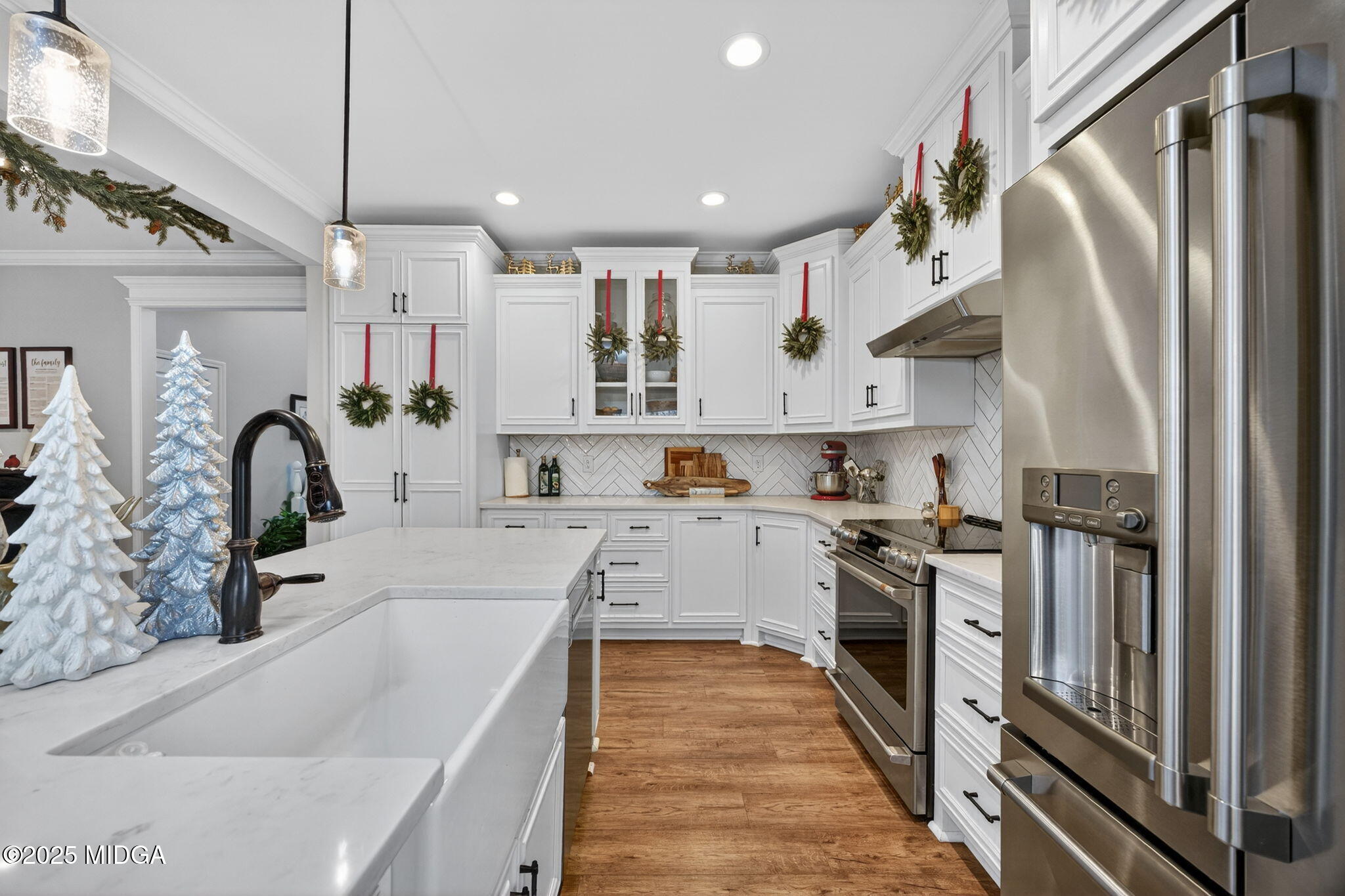 153 Jackson Drive Forsyth, GA 31029 - Photo 3 of 26 a large kitchen with stainless steel appliances lots of counter space wooden floor and a sink