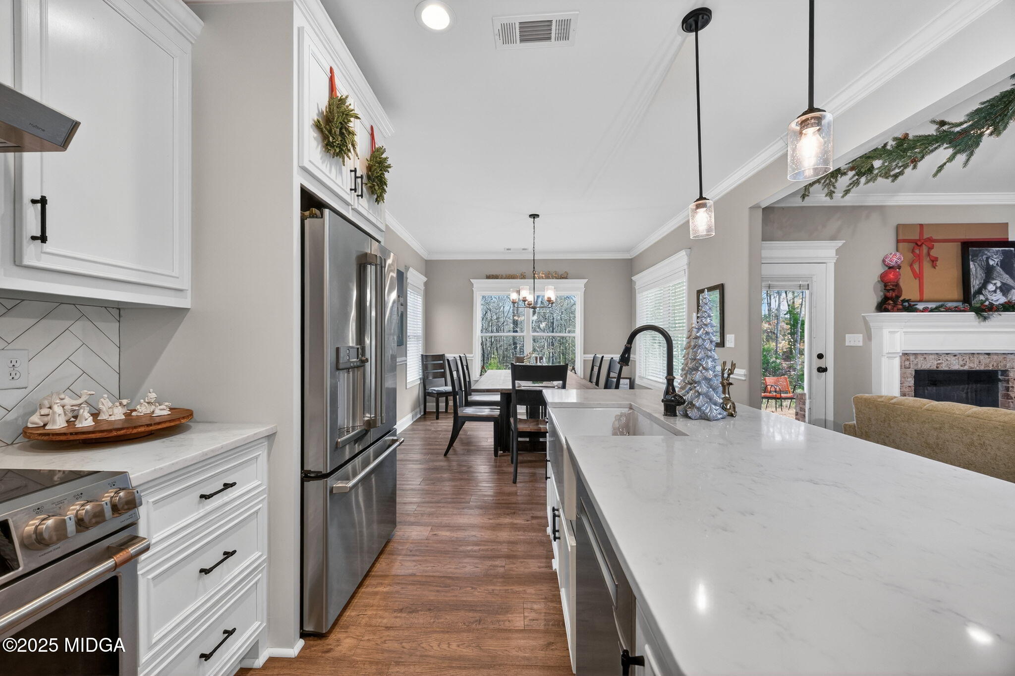 153 Jackson Drive Forsyth, GA 31029 - Photo 5 of 26 a large kitchen with stainless steel appliances granite countertop a stove and cabinets