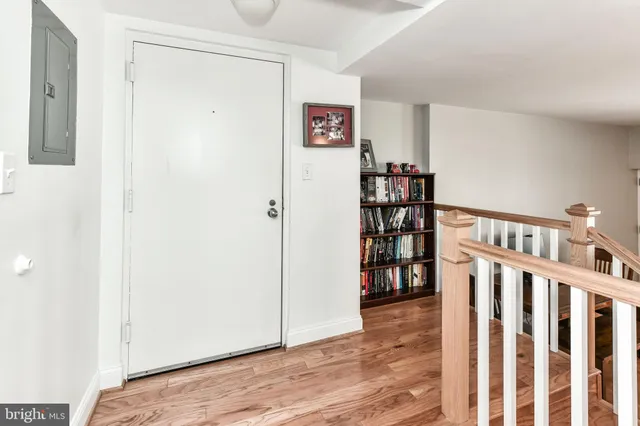 a view of a hallway with wooden floor and entryway