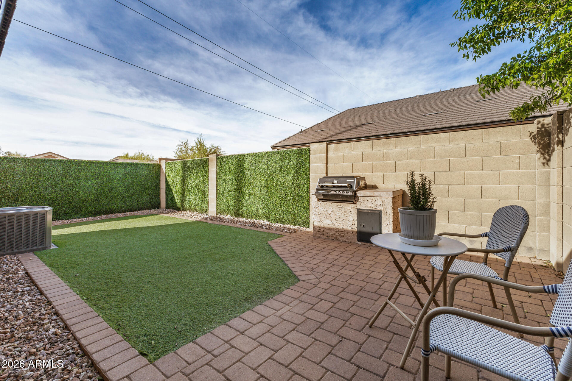 2725 East Mine Creek Road, Unit 1101 Phoenix, AZ 85024 - Photo 28 of 43 a view of a patio with table and chairs with wooden floor and fence