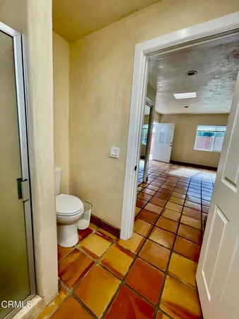 a bathroom with a toilet and a shower