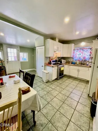 a kitchen with stainless steel appliances granite countertop a stove a sink dishwasher and a refrigerator