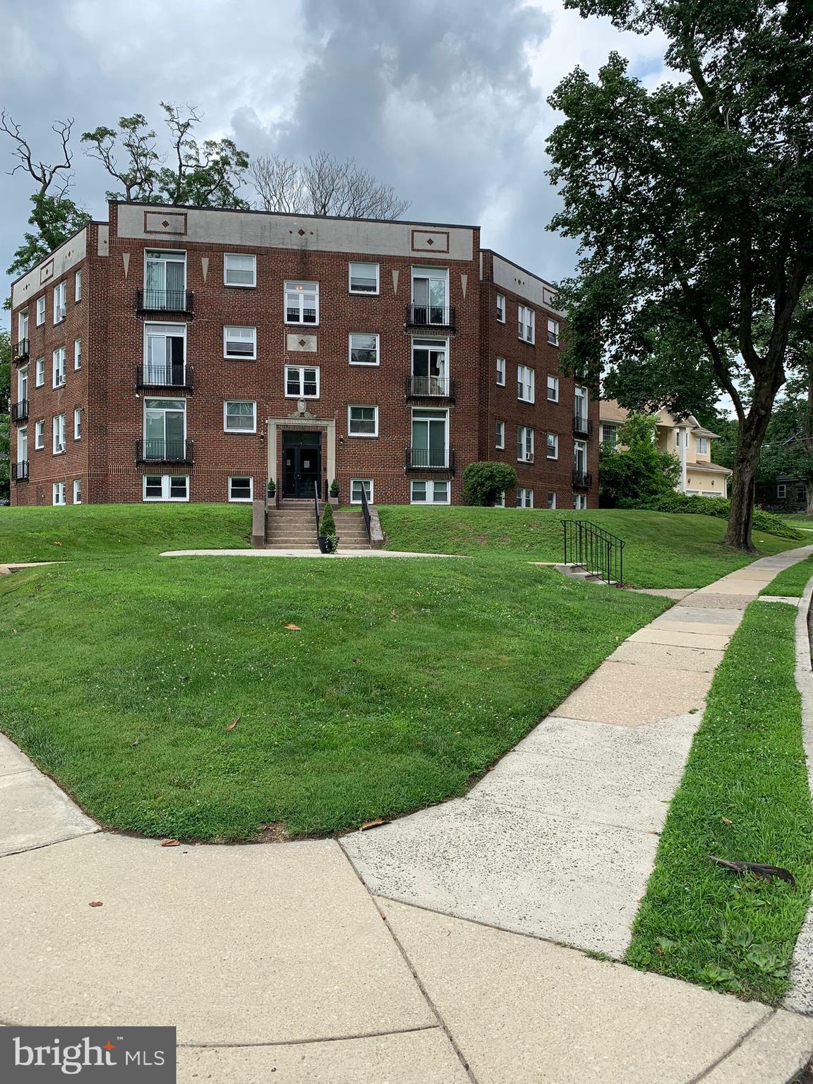 617-625 East Vernon Road, Unit 3A Philadelphia, PA 19119 - Photo 1 of 14 front view of a brick building with a yard